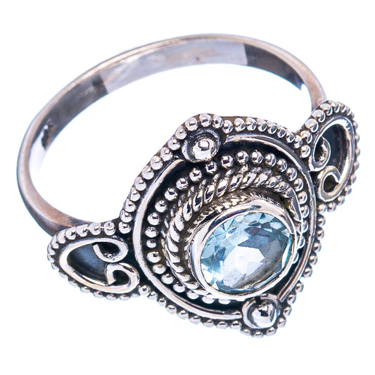 Sterling silver ring with oval blue topaz centerpiece and scalloped side setting