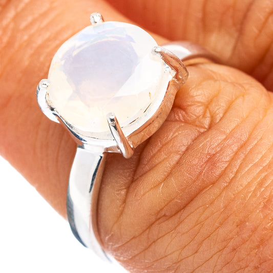 Sterling silver ring with oval opal-style gemstone, prong-set with two side claws