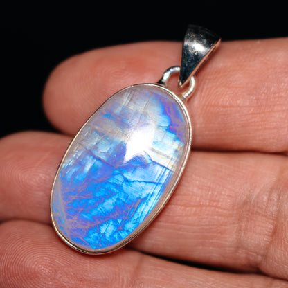 Oval rainbow moonstone pendant in .925 sterling silver bezel, with silver bail