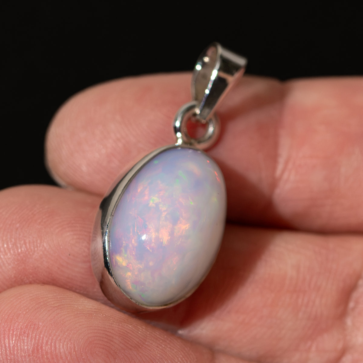 Oval Ethiopian opal pendant in .925 sterling silver bezel, iridescent light colors