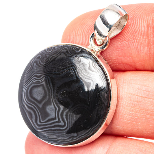 Round psilomelane pendant with dark gray black banded stone in sterling silver bezel