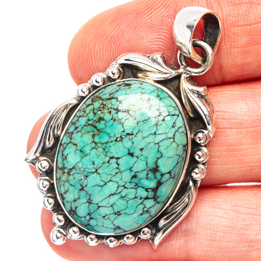 Turquoise oval pendant in .925 sterling silver with ornate bezel and loop bail.
