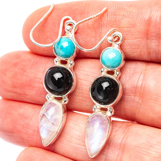 Sterling silver drop earrings with turquoise, black round stones, and iridescent teardrop accents