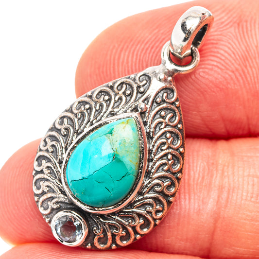 Sterling silver teardrop pendant with turquoise cabochon and blue topaz side stones