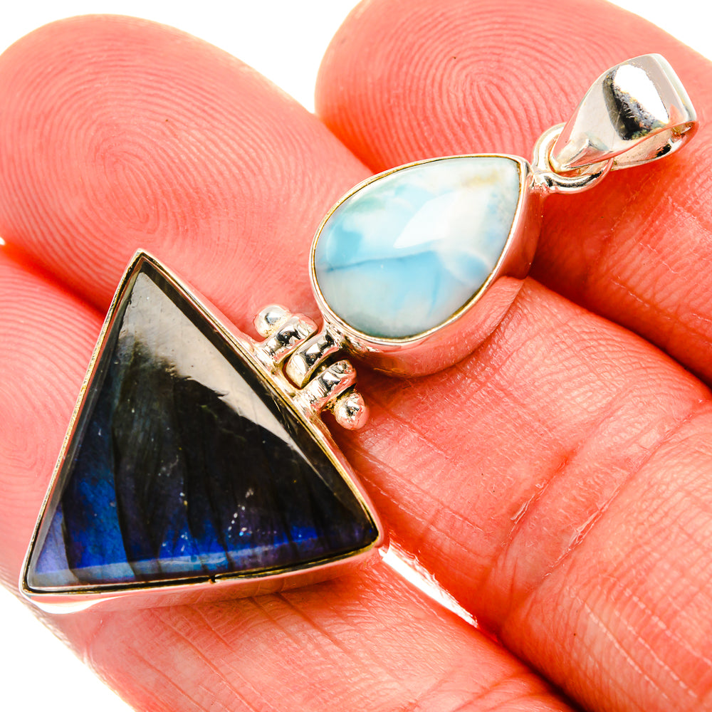 Sterling silver pendant close view: blue teardrop larimar and dark triangular labradorite