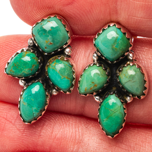 Close-up turquoise cluster earrings with round, oval, and teardrop stones in silver settings