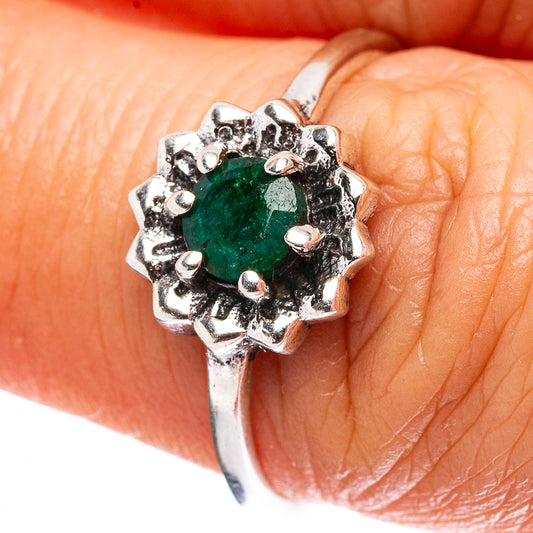 Sterling silver ring with oval green gemstone and scalloped prong setting