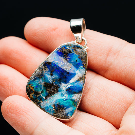 Sterling silver boulder opal teardrop pendant with blue-gold stone, bezel setting