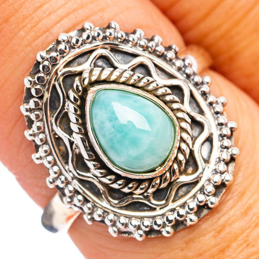 Sterling silver ring with oval turquoise stone and ornate braided bezel
