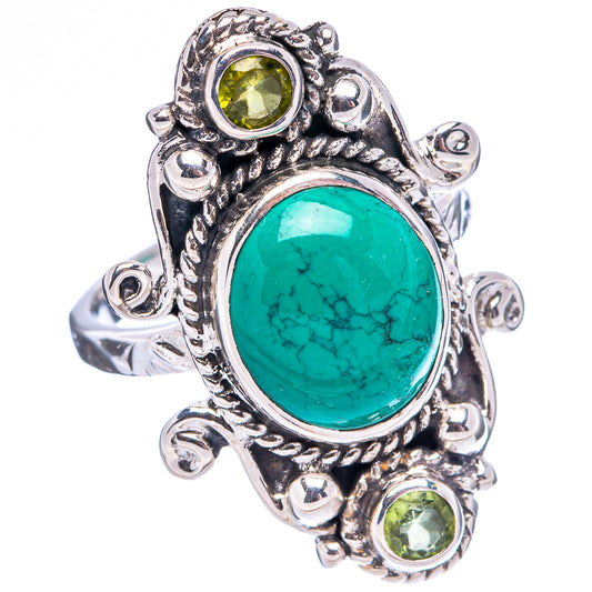 Sterling silver ornate ring with large oval turquoise center and three peridot round stones