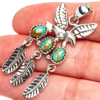 Turquoise cabochon hummingbird pendant in oxidized sterling silver, close-up on stones