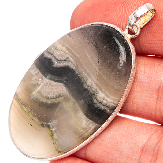 Silver-plated zebra calcite pendant with oval black-and-cream striped stone, bail detail