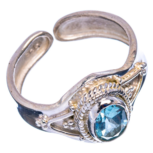 Sterling silver ring with oval blue topaz and braided side detailing, size 7