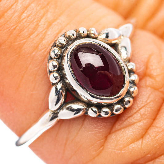 Dainty garnet ring in .925 sterling silver with oval red gemstone bezel setting