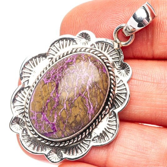 Sterling silver purpurite pendant with oval purple-and-gold stone, textured floral border.
