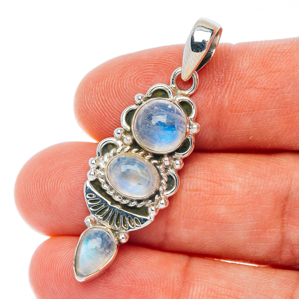 Sterling silver pendant with three iridescent moonstone cabochons, scalloped frame