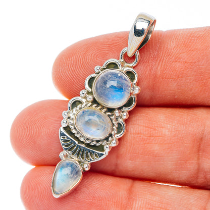 Sterling silver pendant with three iridescent moonstone cabochons, scalloped frame