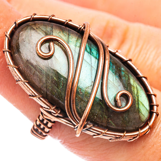 Oxidized copper wire-wrapped labradorite oval ring, green-blue gemstone flash