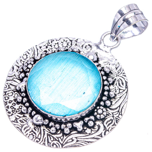 German silver blue onyx pendant with round blue cabochon and decorative filigree bezel