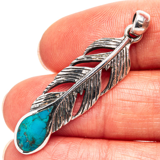 Sterling silver feather pendant with turquoise teardrop stone and textured leaf detail