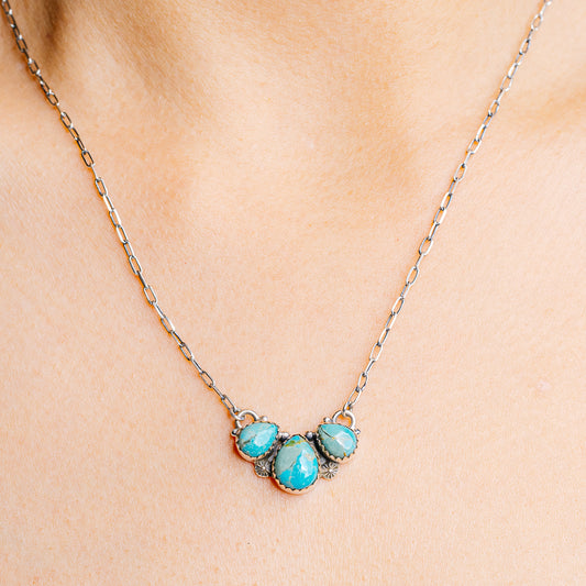 Turquoise stone pendant necklace with sterling silver chain and oval cluster centerpiece