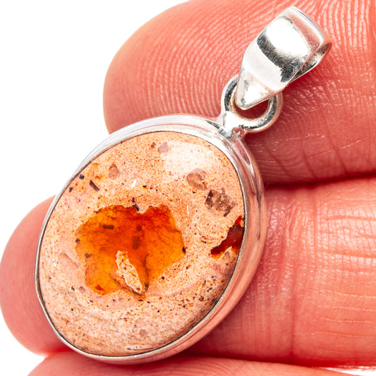 Sterling silver oval fire opal pendant with orange-red gemstone and textured matrix
