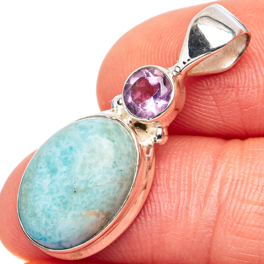 Larimar pendant with oval blue stone, purple round accent, .925 sterling silver frame