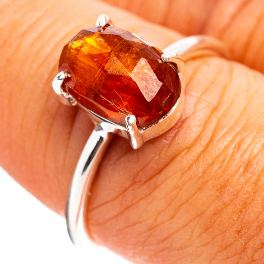 Sterling silver ring with orange-red faceted gemstone and prong setting, size 7.75