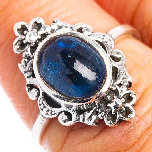 Dainty .925 sterling silver ring with oval blue kyanite cabochon and floral bezel