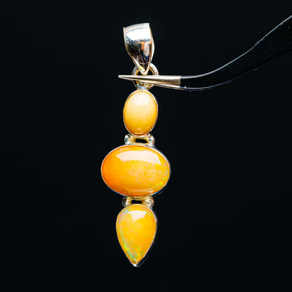 Sterling silver opal pendant with three amber-orange stones: oval, round, and teardrop
