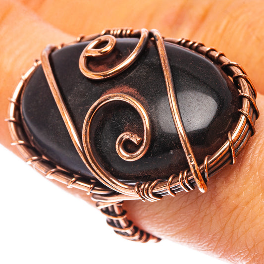 Oxidized copper wire jet-stone ring, oval black cabochon on finger