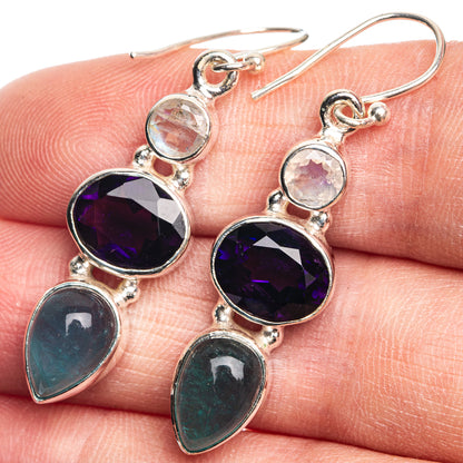 Sterling silver drop earrings with purple round and blue-green teardrop gemstones, plus opal accents