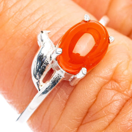 Sterling silver bird ring with red-orange carnelian cabochon and prong setting