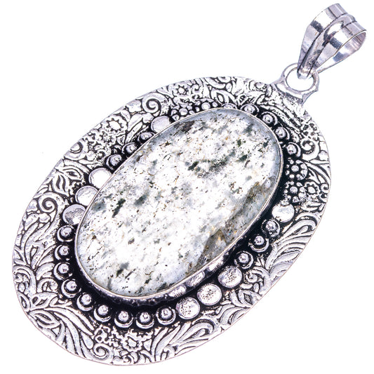 German silver oval pendant with mottled green-gray stone cabochon and scrolling filigree