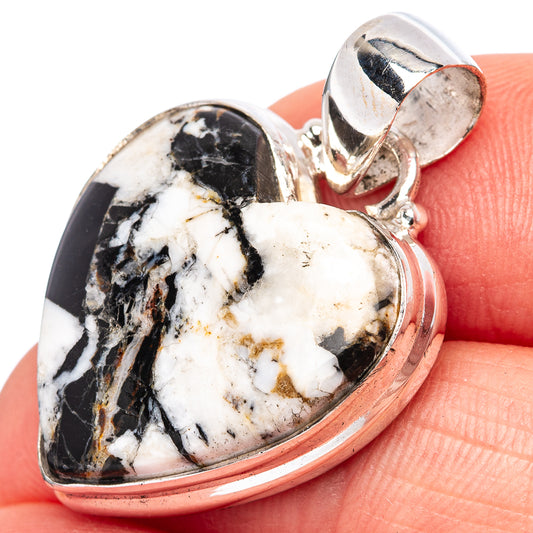 Heart-shaped sterling silver pendant with marbled black-and-white gemstone face and bail.