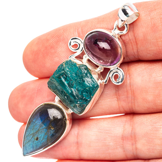 Sterling silver 3-stone pendant with purple, green, and dark blue gemstones.