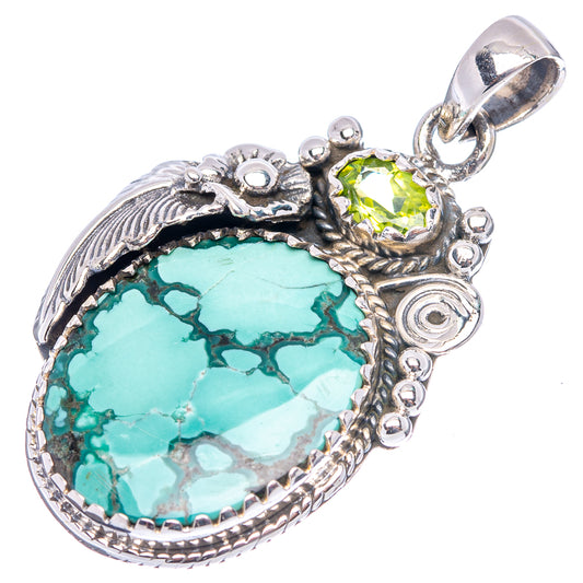 Sterling silver turquoise teardrop pendant with green center stone, top bail and scrollwork.
