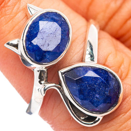 Sterling silver cat ring with two oval blue gemstone cabochons in claw settings