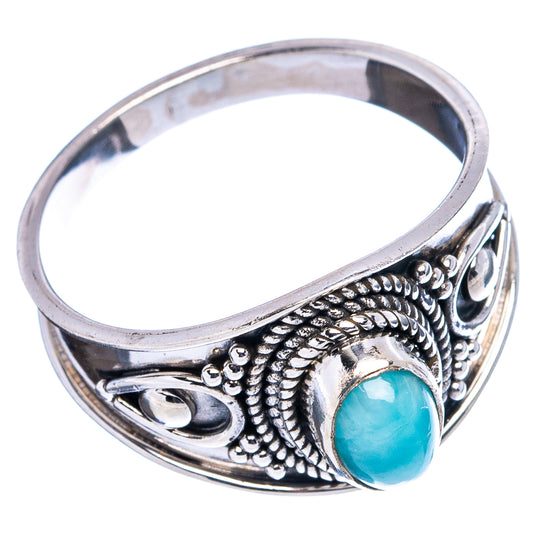 Sterling silver ring with oval light-blue larimar cabochon and engraved band details