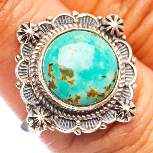 Turquoise oval stone silver ring with ornate bezel and starburst details