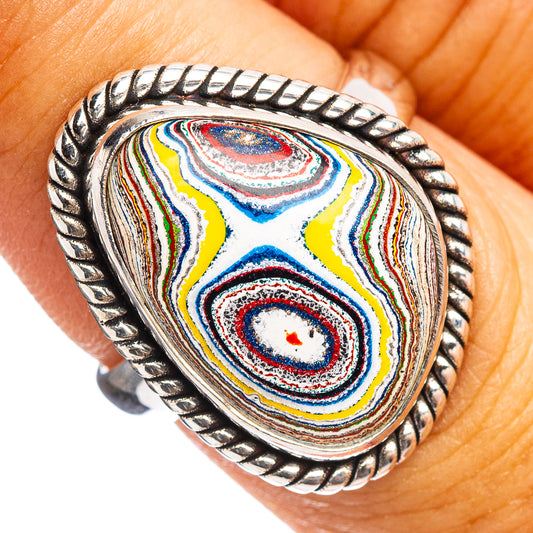 Sterling silver oval ring with marbled blue, yellow, and red stone close-up