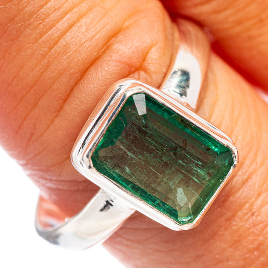 Sterling silver ring with faceted rectangular green gemstone, open prong setting
