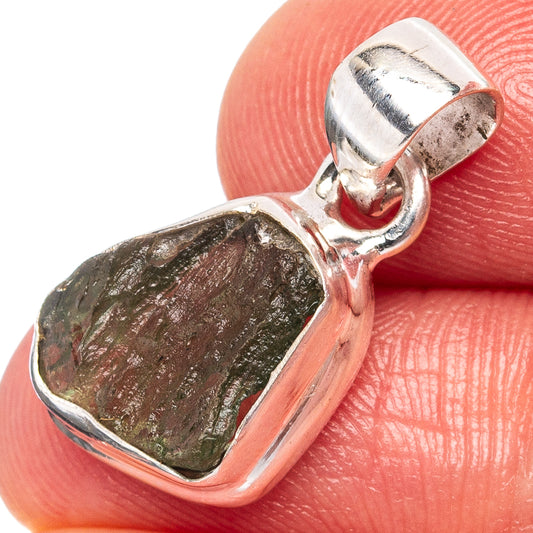 Silver bezel heart pendant with rough green moldavite stone, top bail visible.
