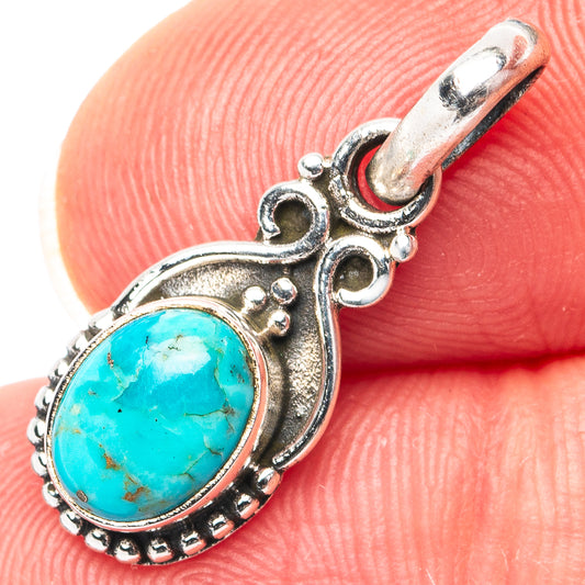 Sterling silver turquoise oval pendant with ornate bezel and top bail
