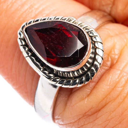 Faceted garnet ring in .925 sterling silver with oval gemstone and ornate silver band
