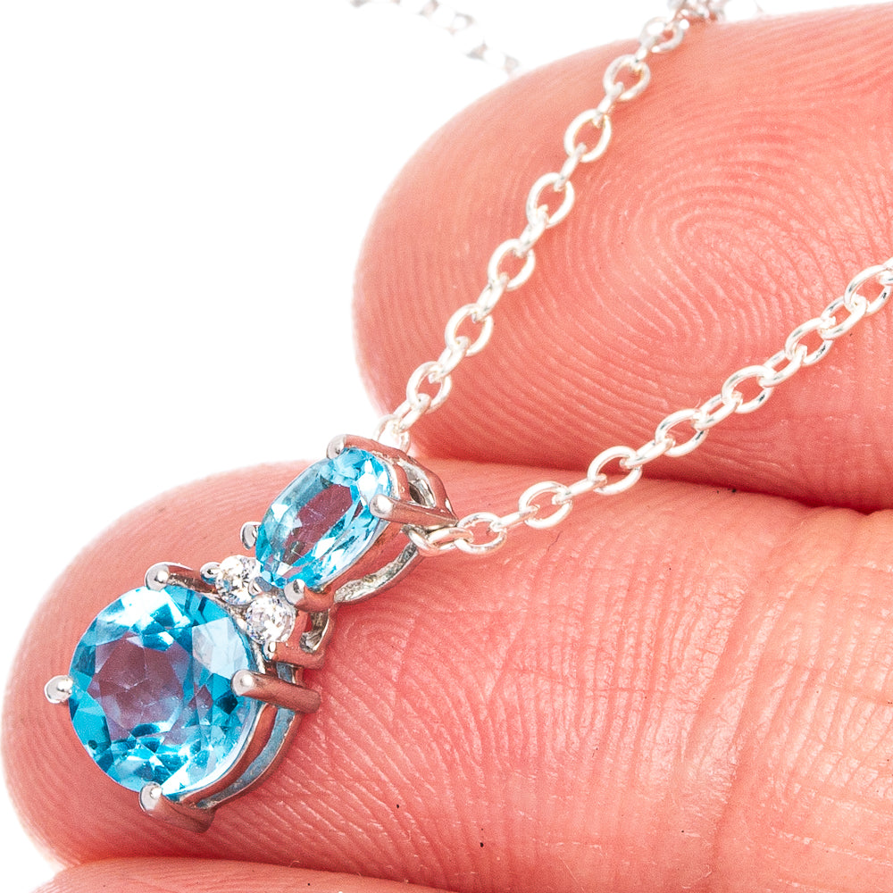 Blue topaz pendant necklace with oval stones on silver chain, lobster clasp detail