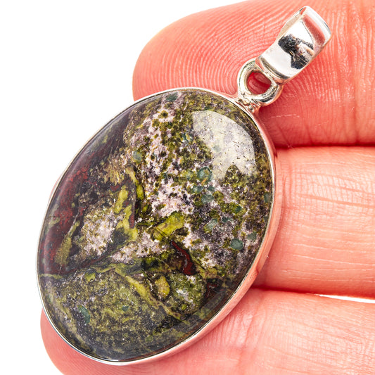 Close-up oval dragon's blood stone pendant in .925 sterling silver, speckled purple-green
