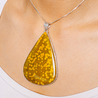 Ocean jasper teardrop pendant on silver chain, amber yellow mottled stone
