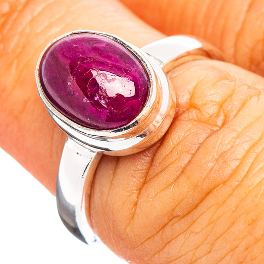 Oval ruby cabochon sterling silver ring on hand, size 6.25