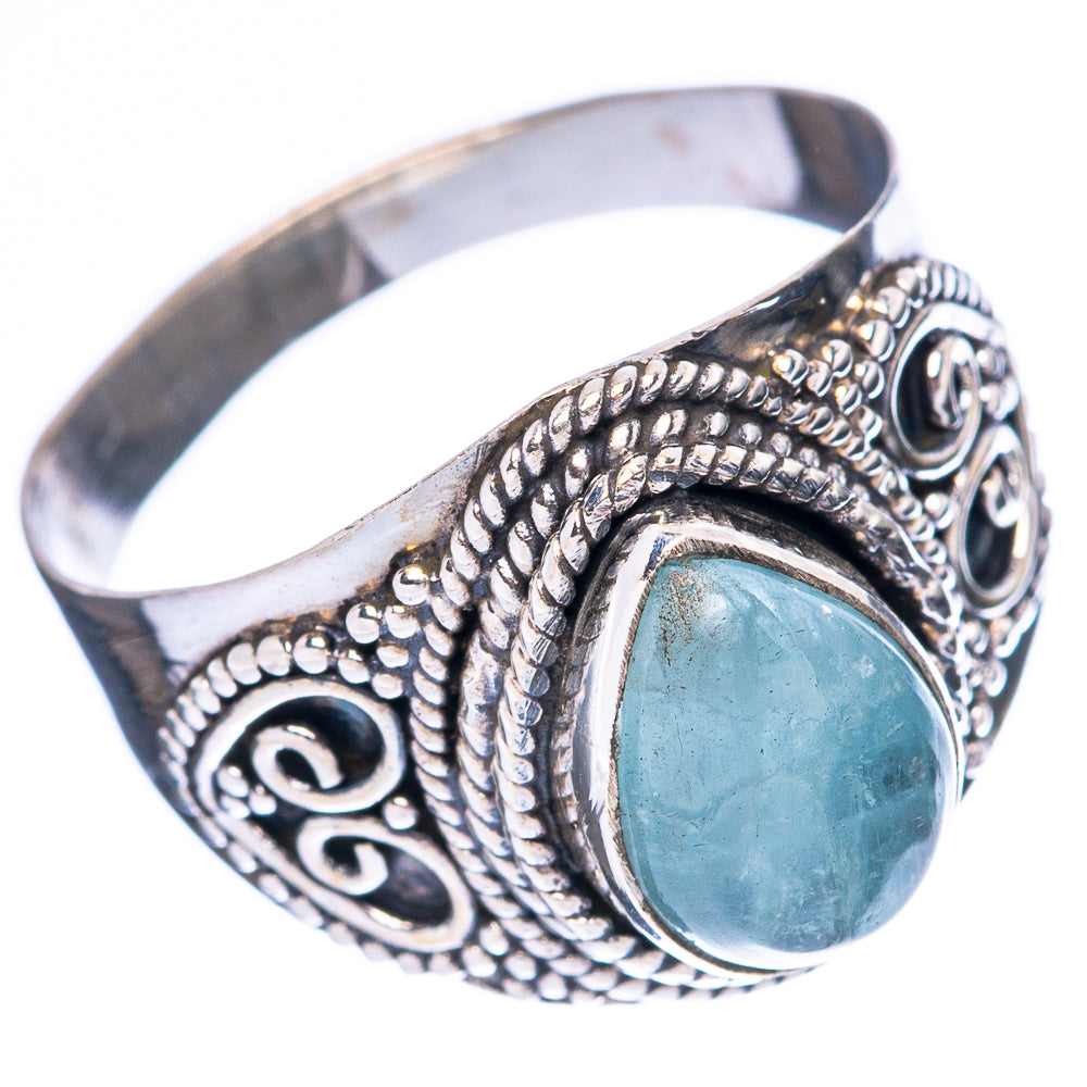 Sterling silver aquamarine ring with oval blue stone and detailed swirled side setting